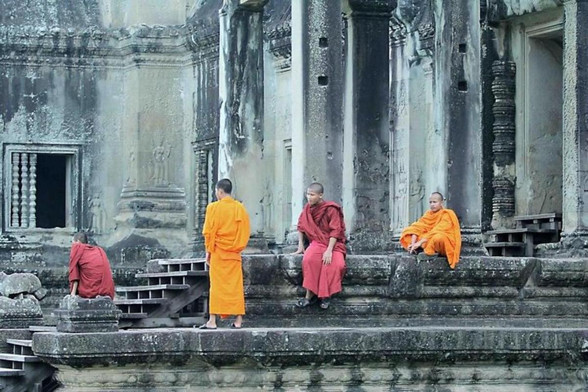 a group of monks sitting on the ledge of a building