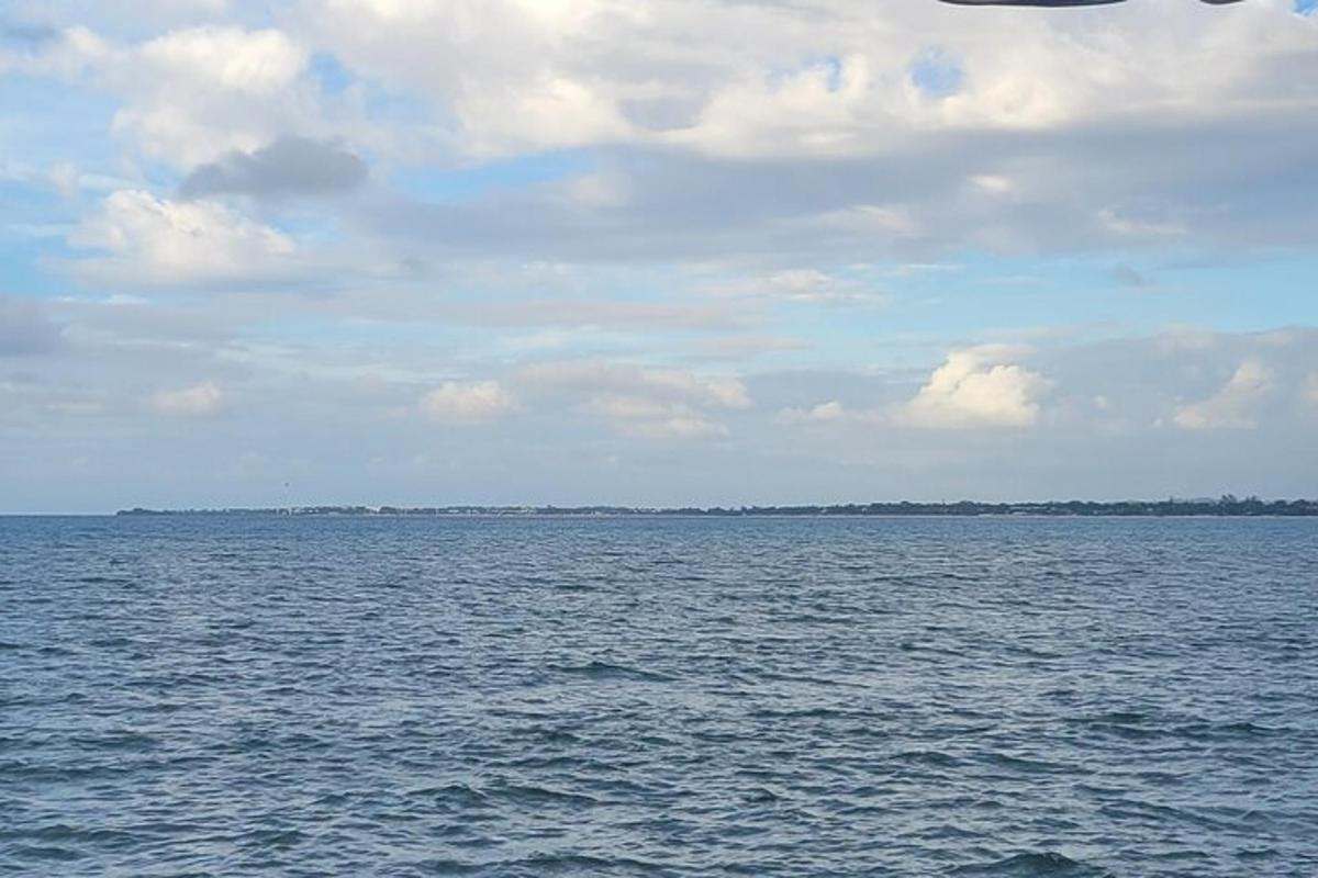 a large body of water with a cloudy sky