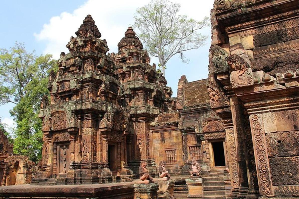 a building with two towers with people in front