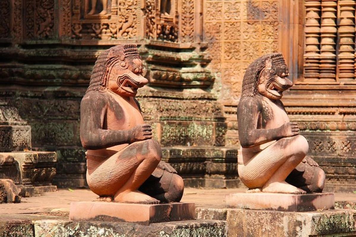 two statues are sitting in front of a building