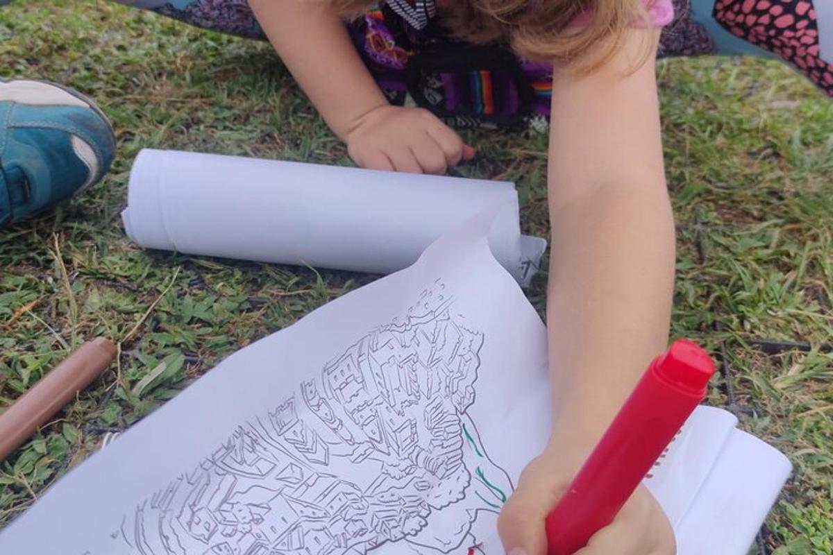 a little girl drawing on a piece of paper