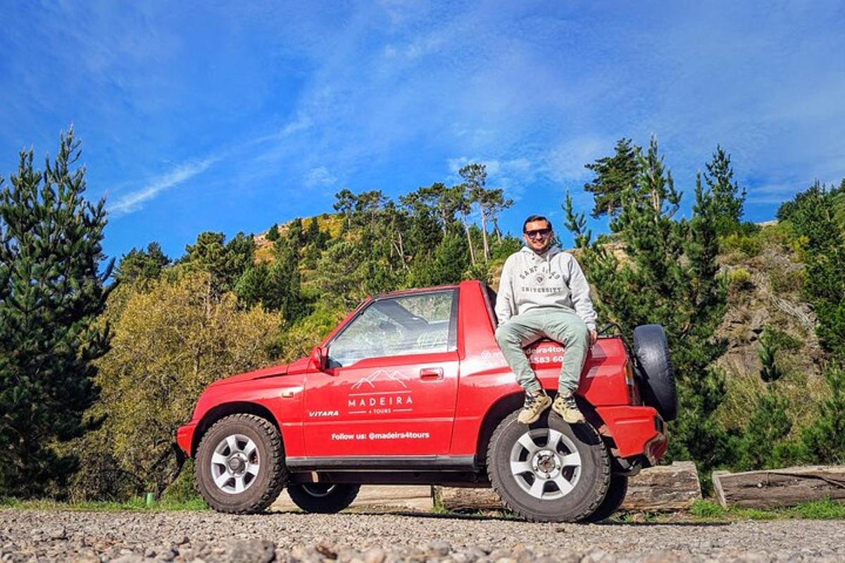 un hombre sentado en la parte trasera de un camión rojo