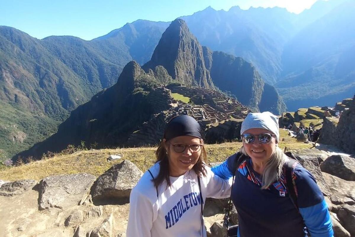 two women standing on top of a mountain