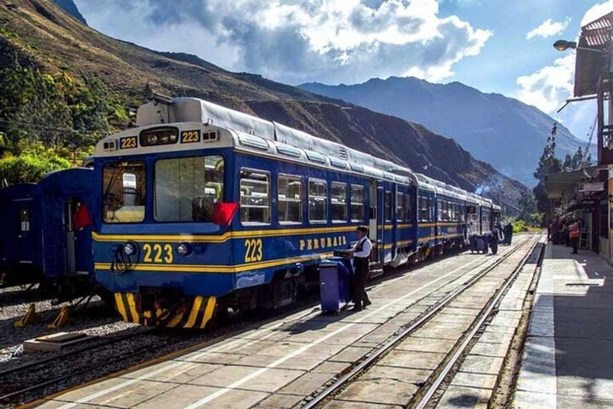 a blue and yellow train is on the tracks