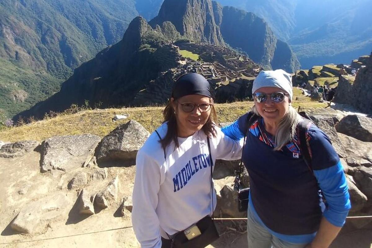 two women standing on top of a mountain