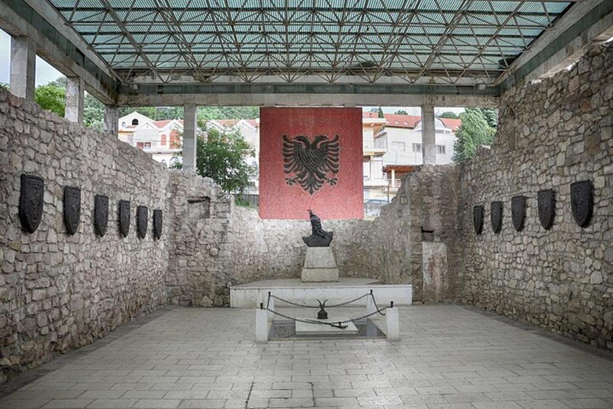 a stone building with a bench and a flag
