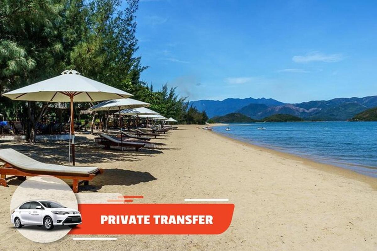 a toy car sitting on a beach with umbrellas