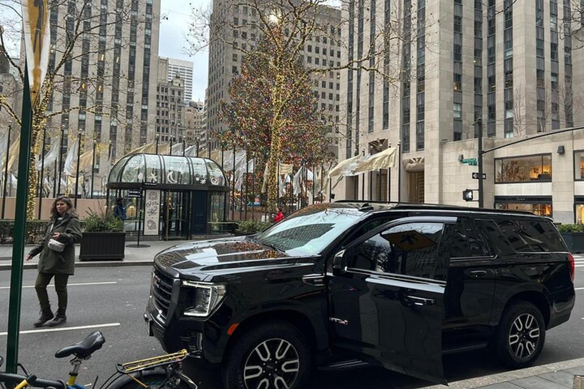 a black suv parked on a street in a city