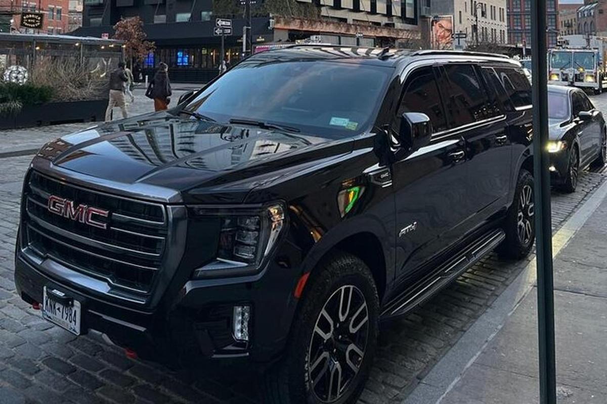 a black suv parked on the side of a street