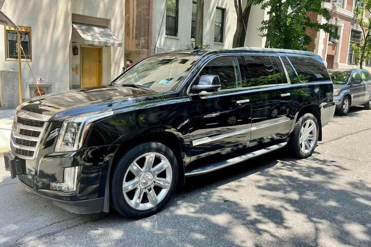 a black suv parked on the side of a street