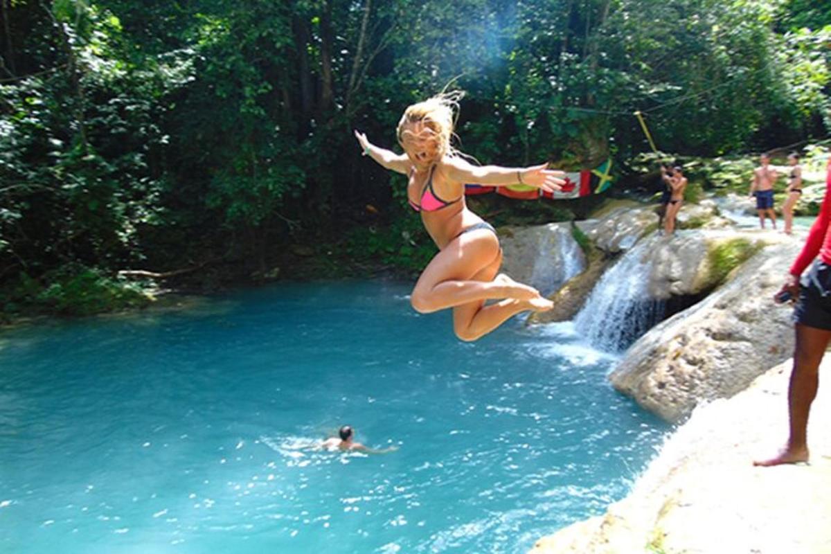 una mujer en bikini saltando a un río