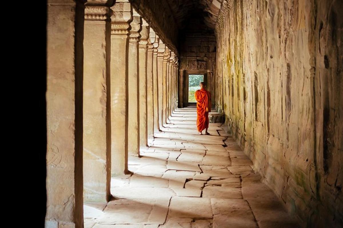 a monk walking down a hallway in a building