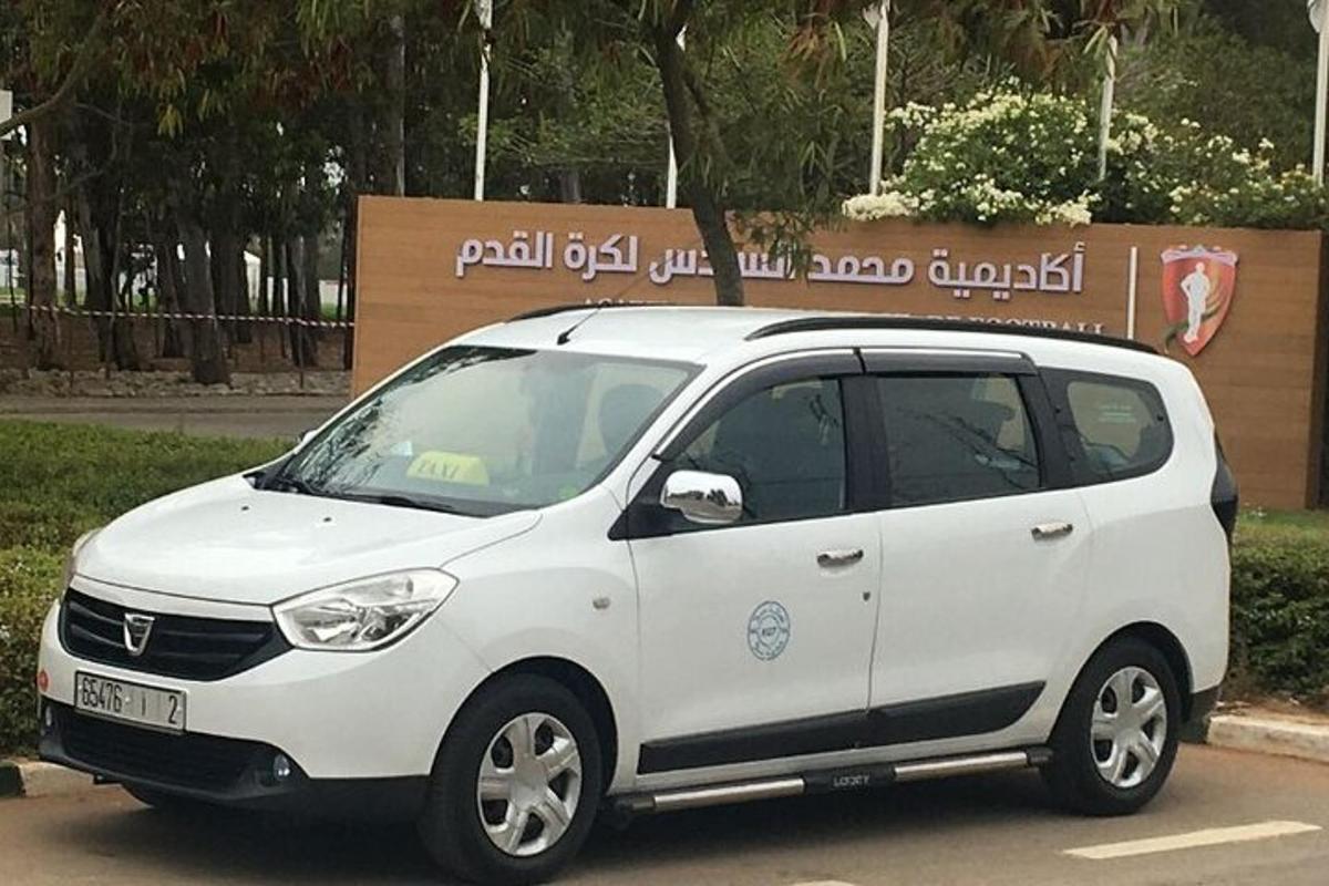 a small white car parked in a parking lot