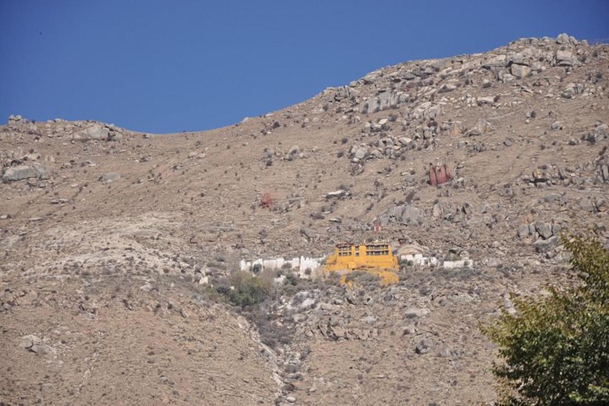 a yellow bulldozer on a rocky mountain