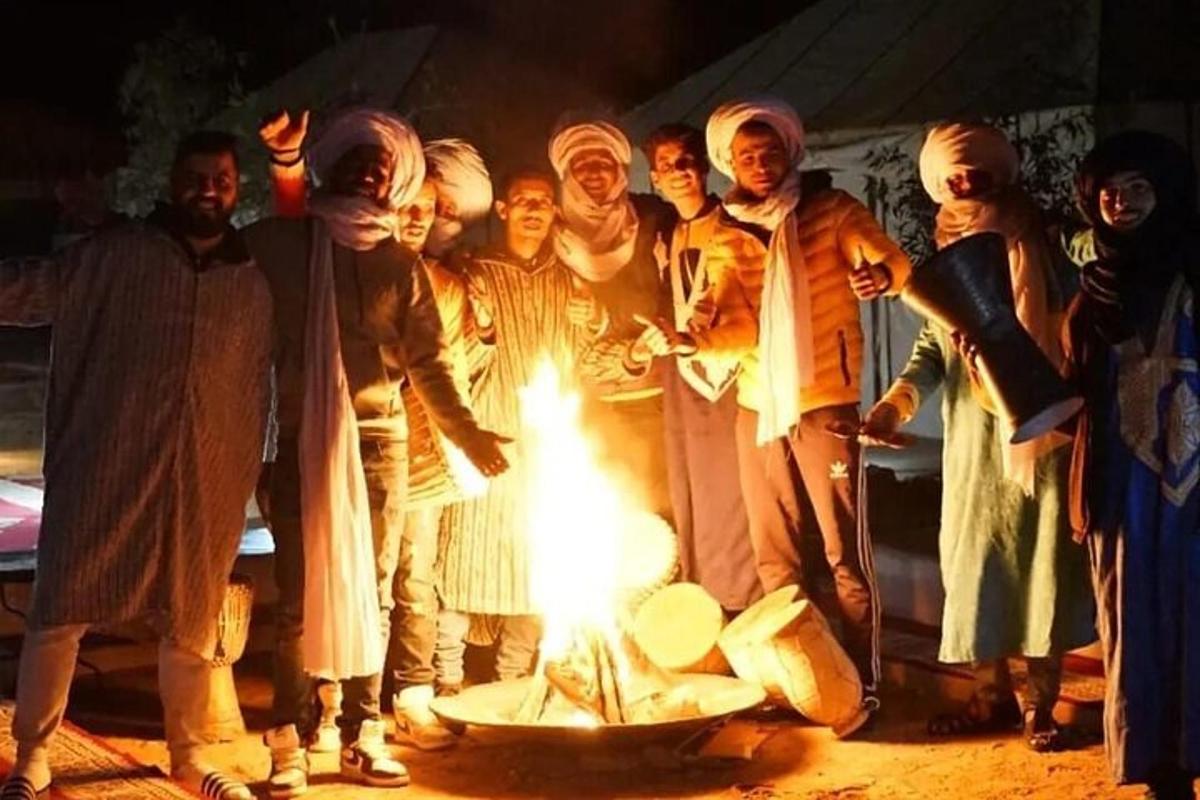 a group of people standing around a fire
