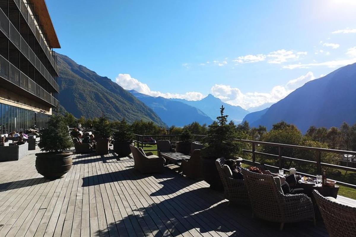 a balcony with chairs and a view of mountains