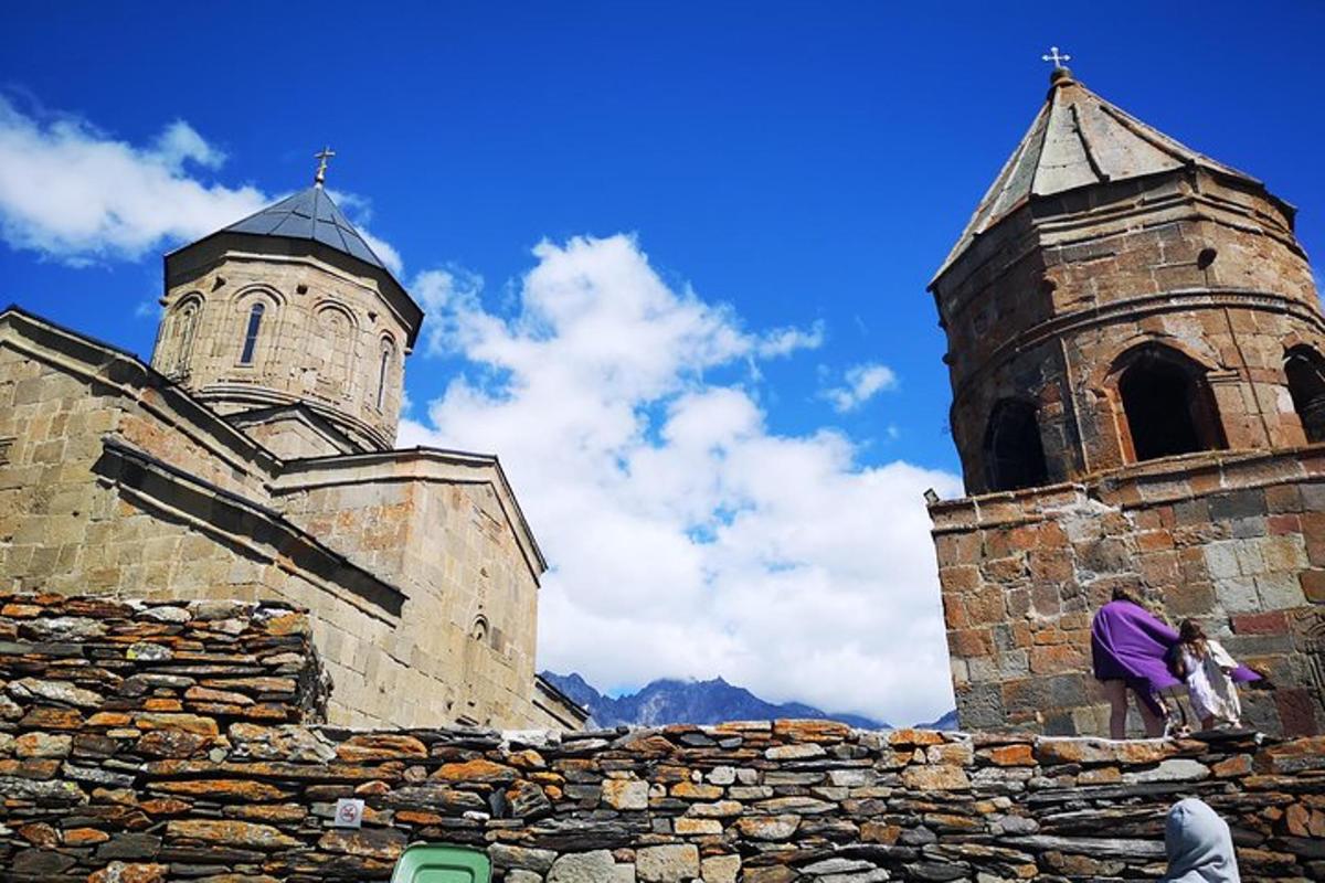 a person standing on a stone wall next to a church