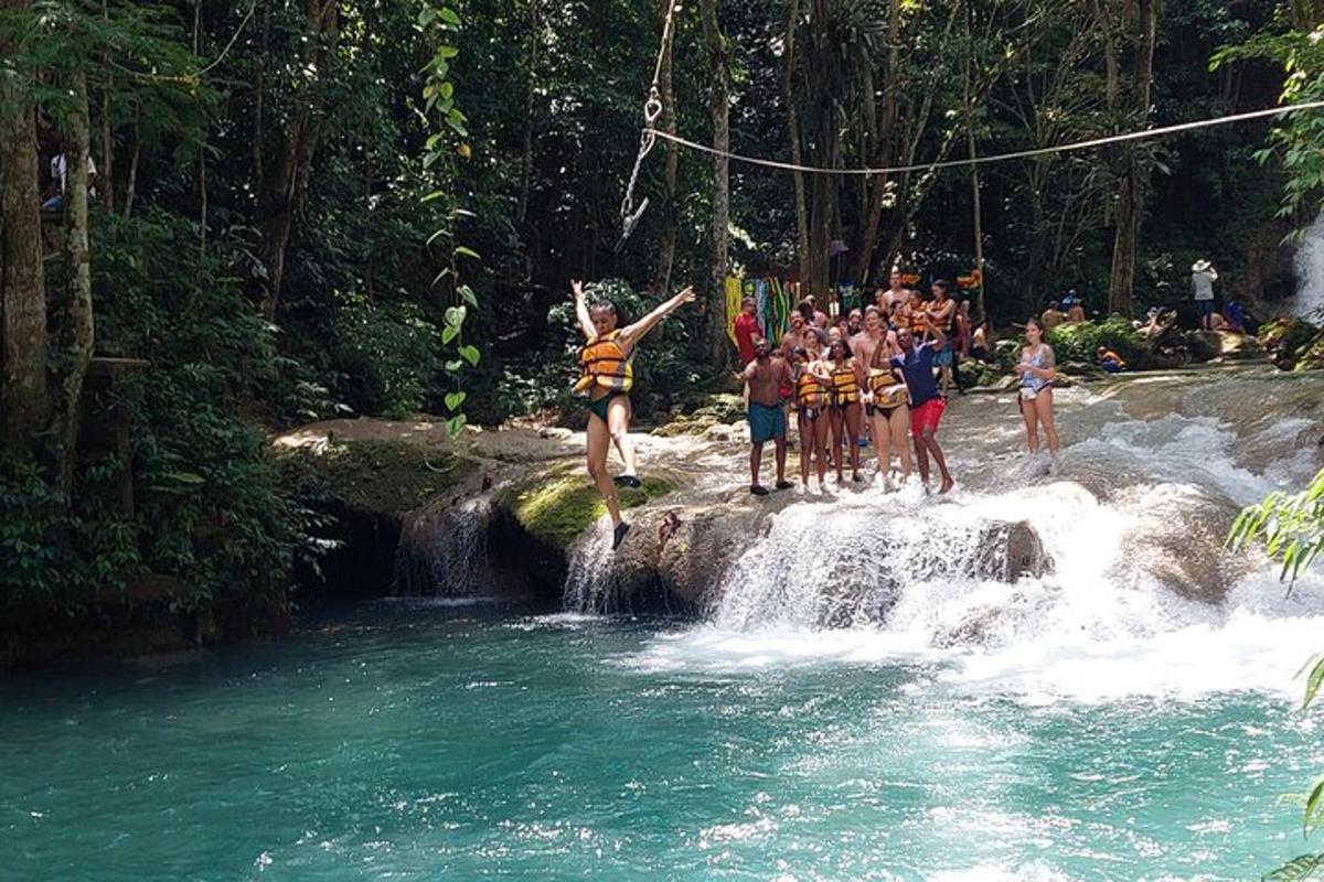 Un grupo de personas saltando de una cascada a un río.