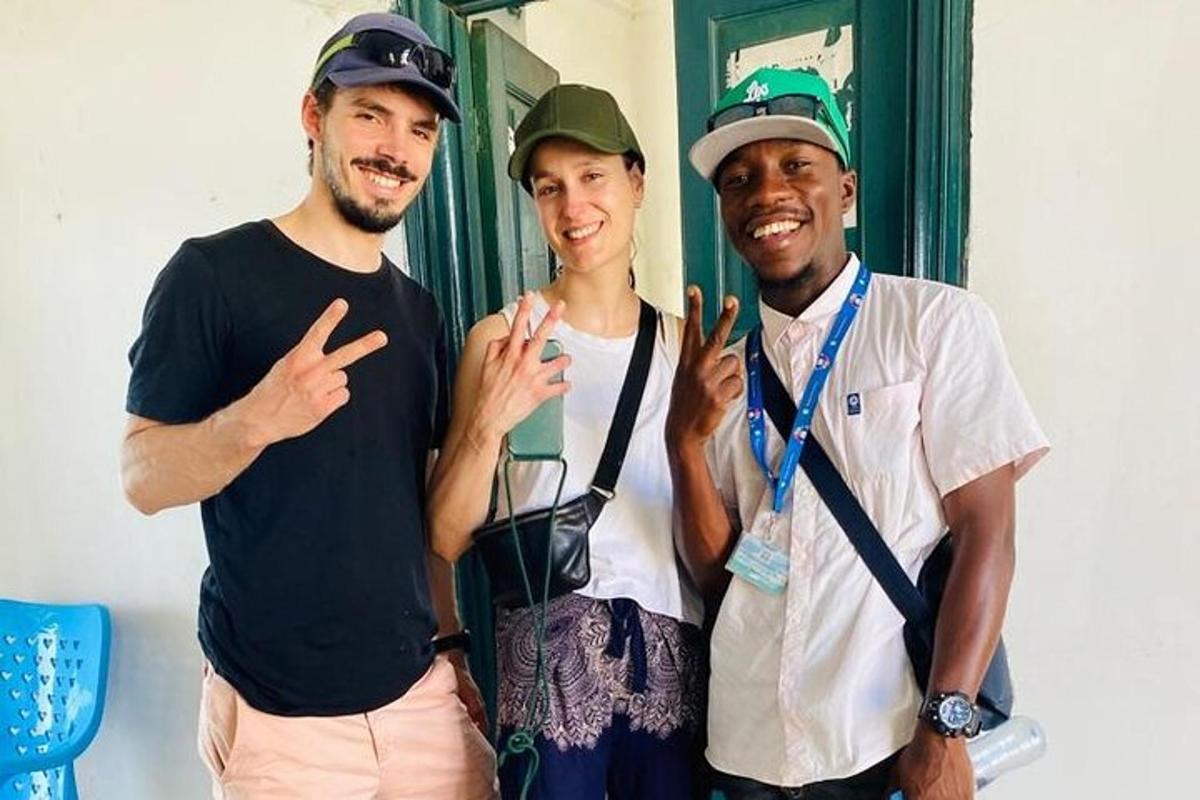two men and a woman posing for a picture
