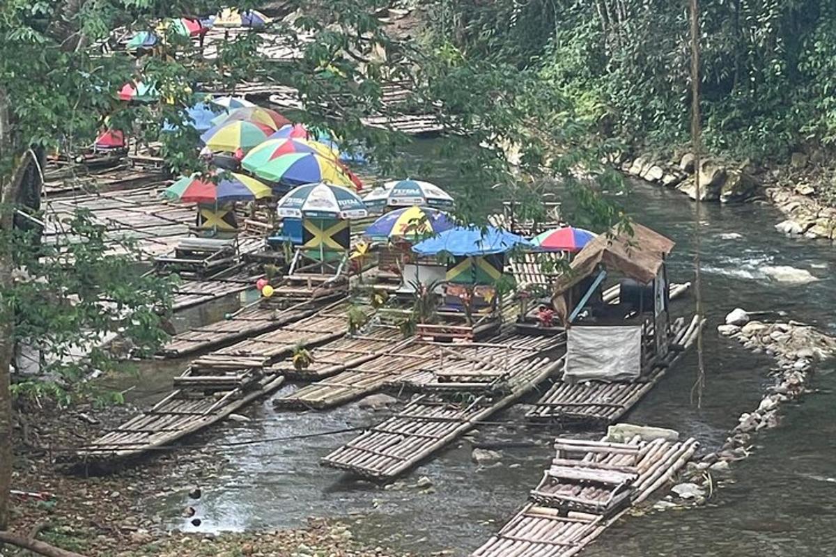 a group of rafts with umbrellas and chairs in a river