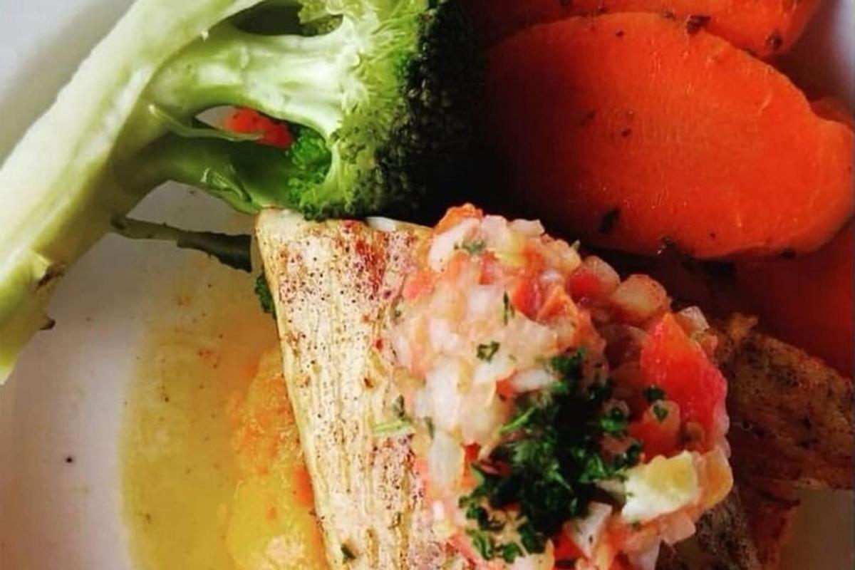 a plate of food with a sandwich and vegetables
