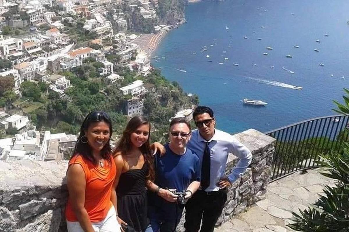 um grupo de pessoas em pé na beira de uma montanha