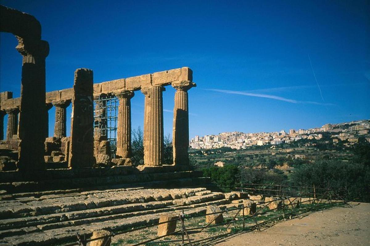 an ancient temple with a city in the background