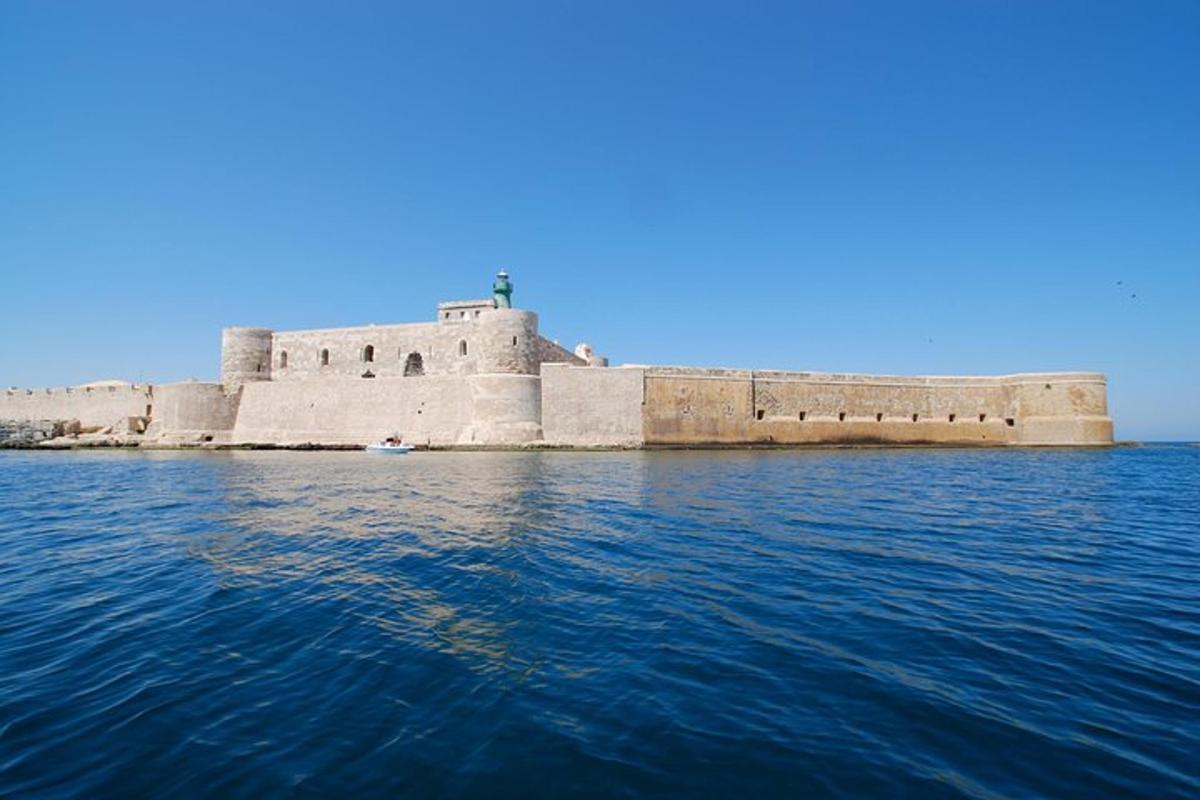 a large stone building in the middle of the water