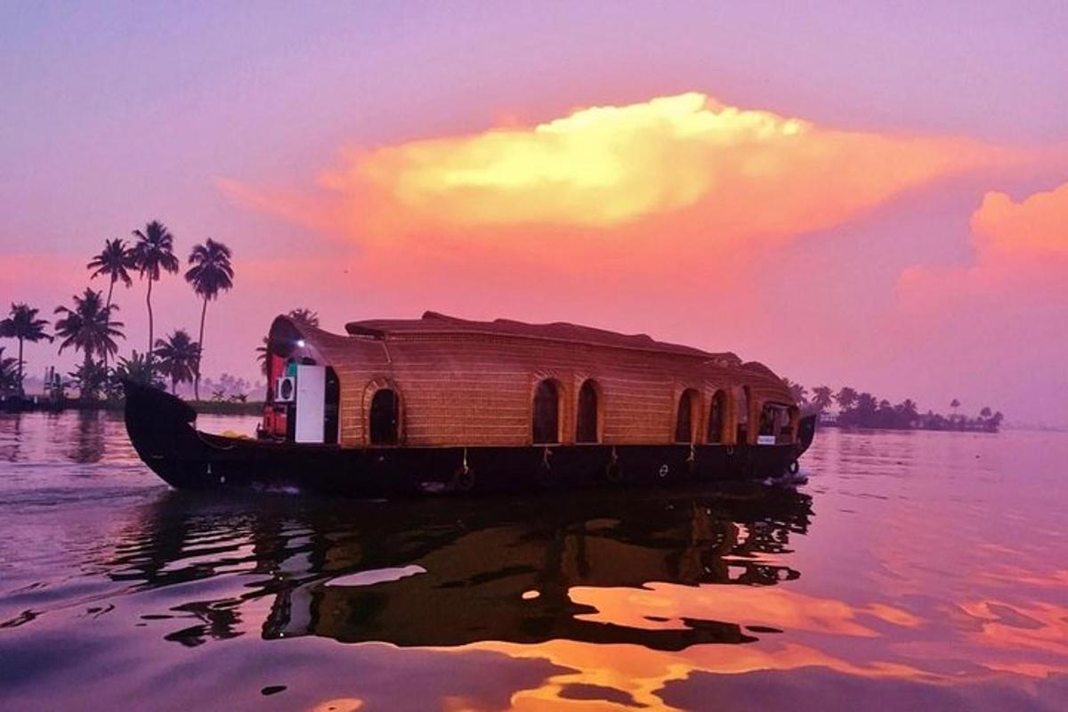 a house boat on the water with a sunset