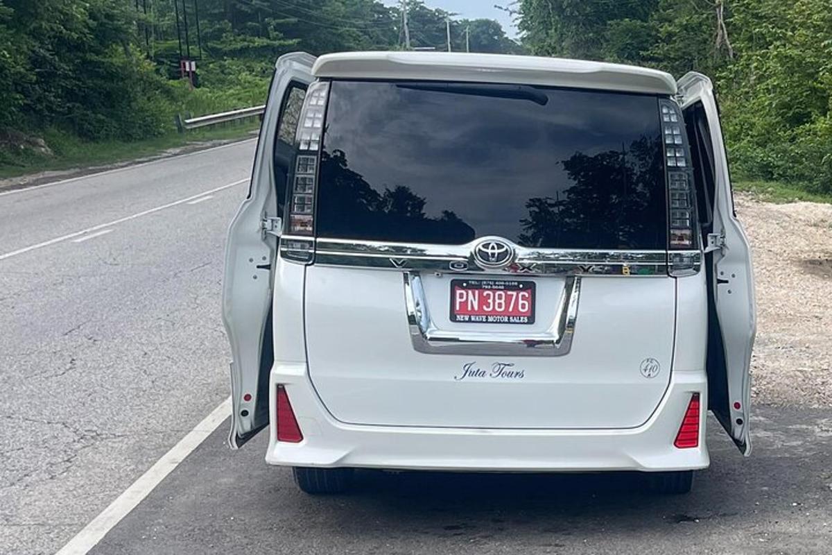 bílé auto zaparkované na kraji silnice
