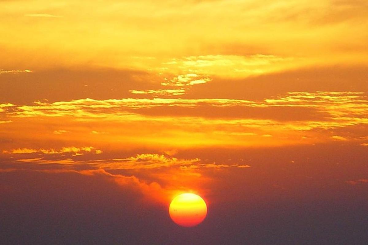 an orange sunset with the sun in the sky