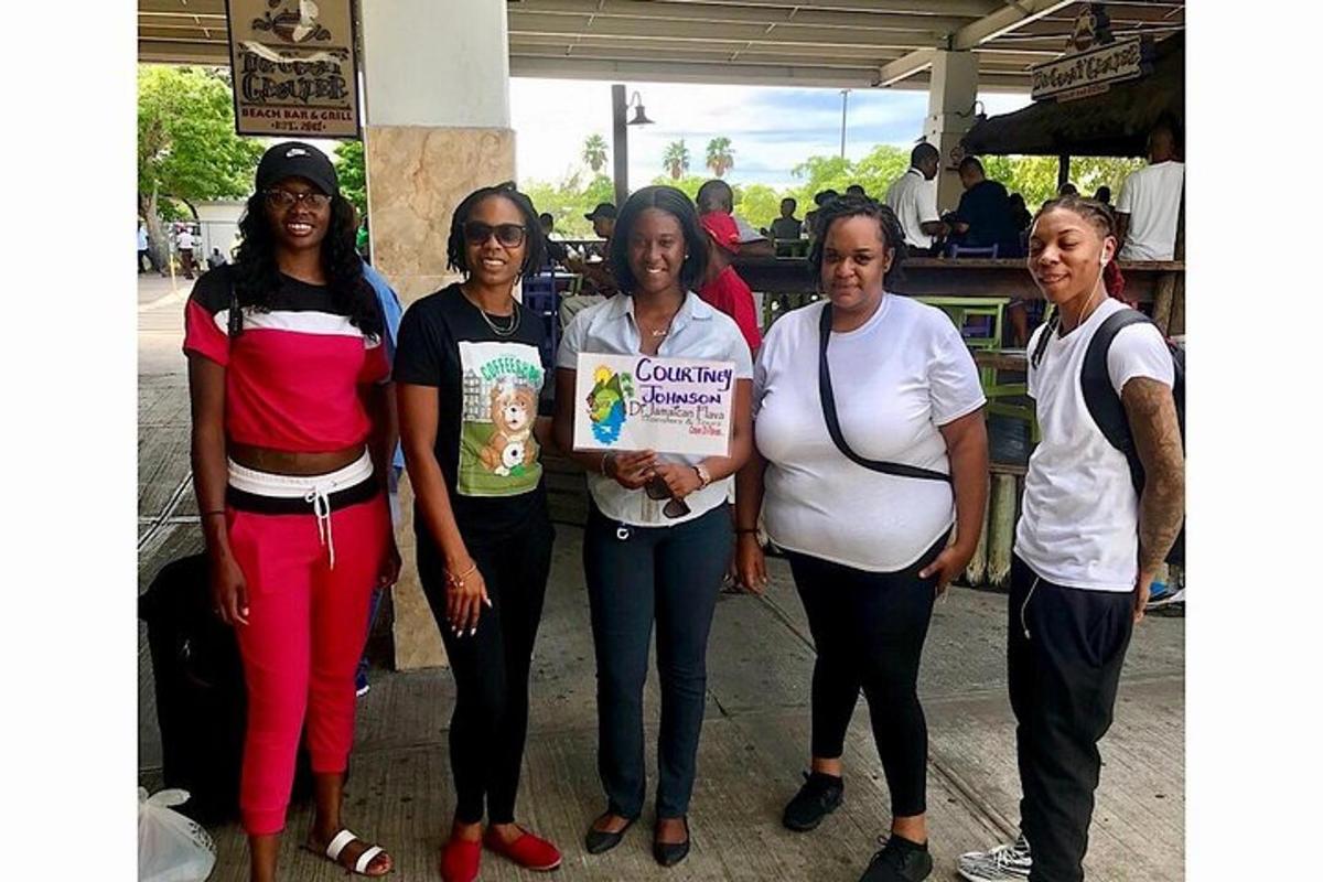 a group of women standing together holding a sign