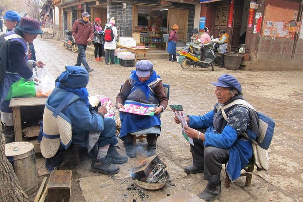a group of people sitting around in a street