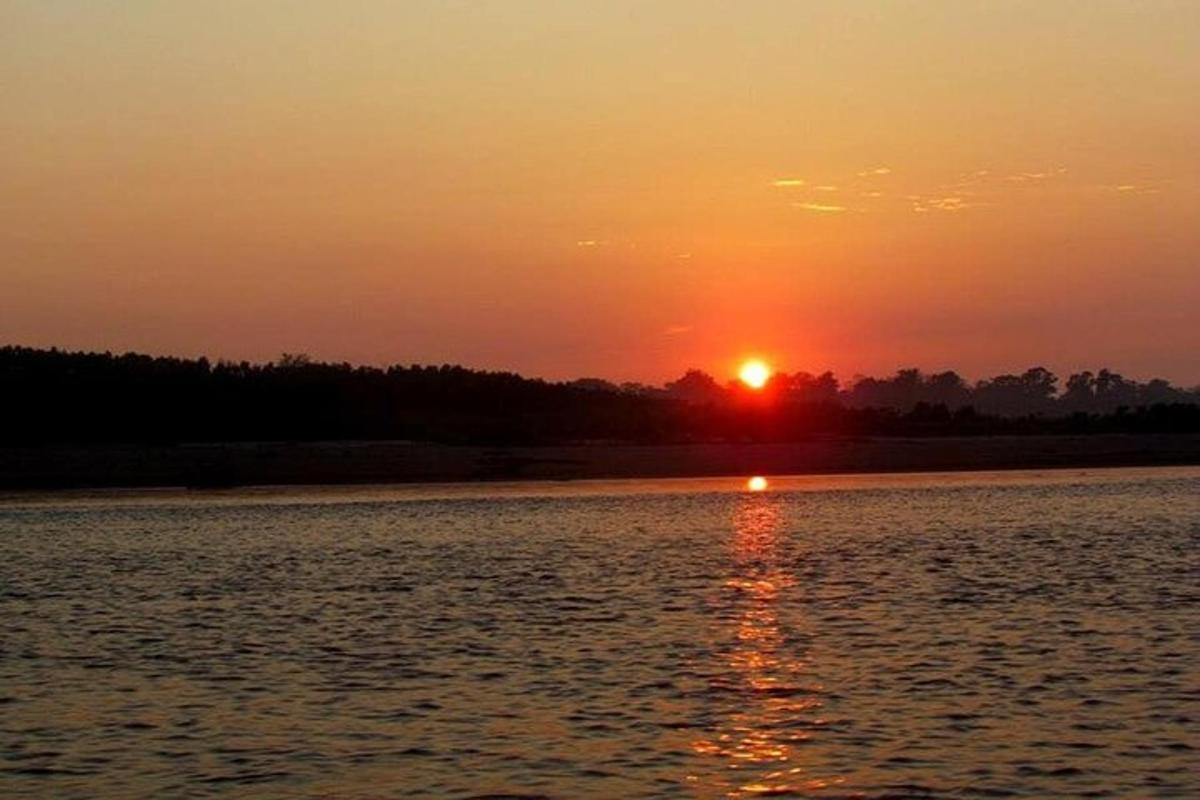 a sunset over a body of water with the sun setting