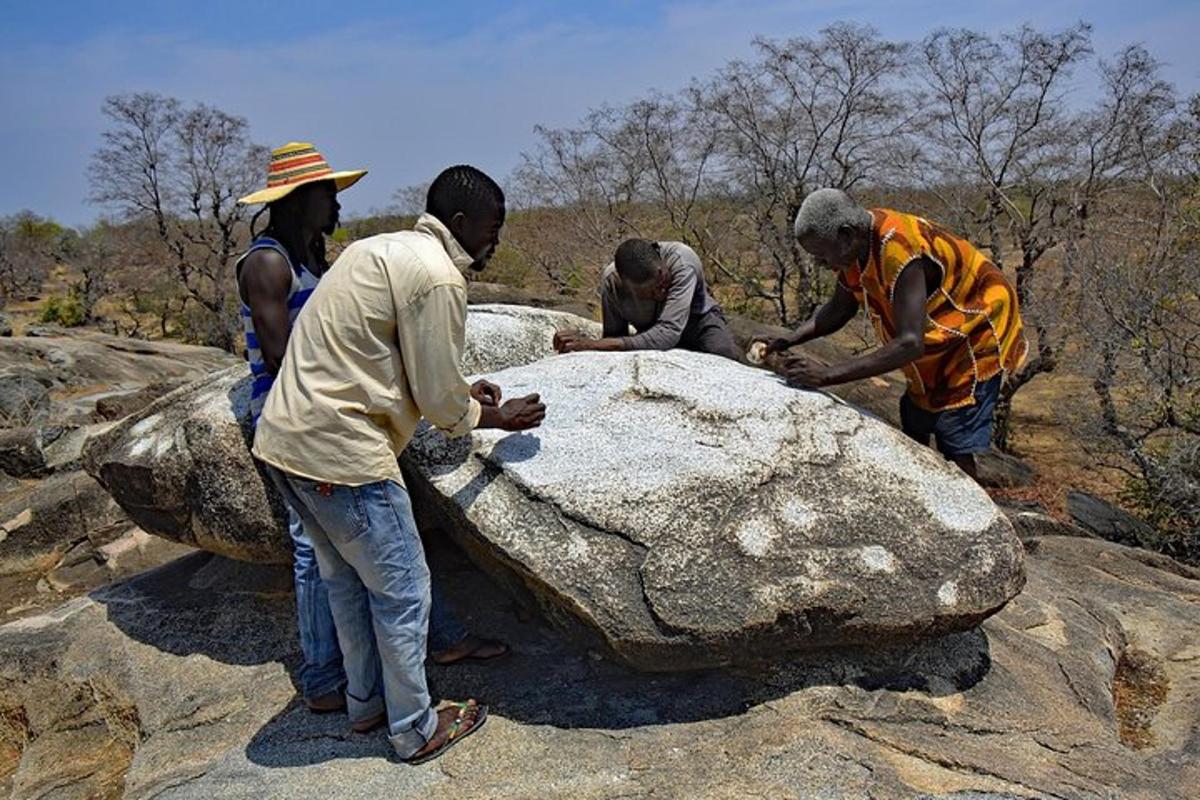a group of people working on a rock