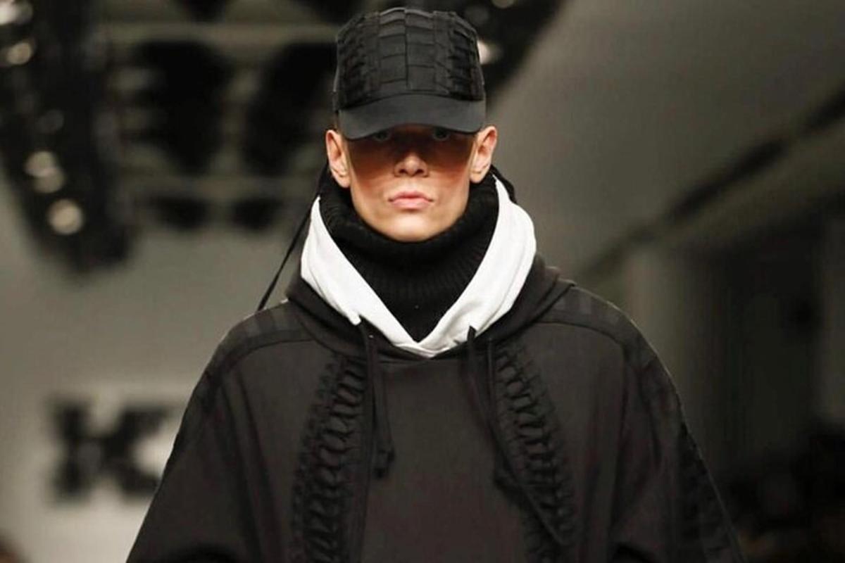 a man wearing a black jacket and a hat