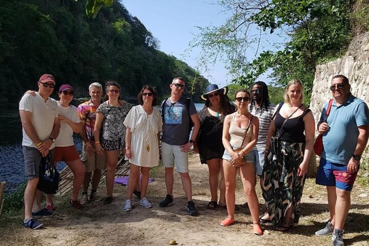 cilvēku grupa pozē fotografēšanai pie upes