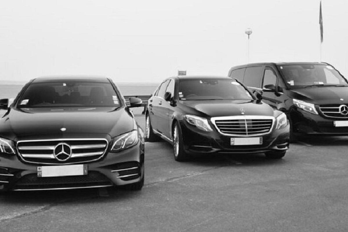 a group of three cars parked in a parking lot