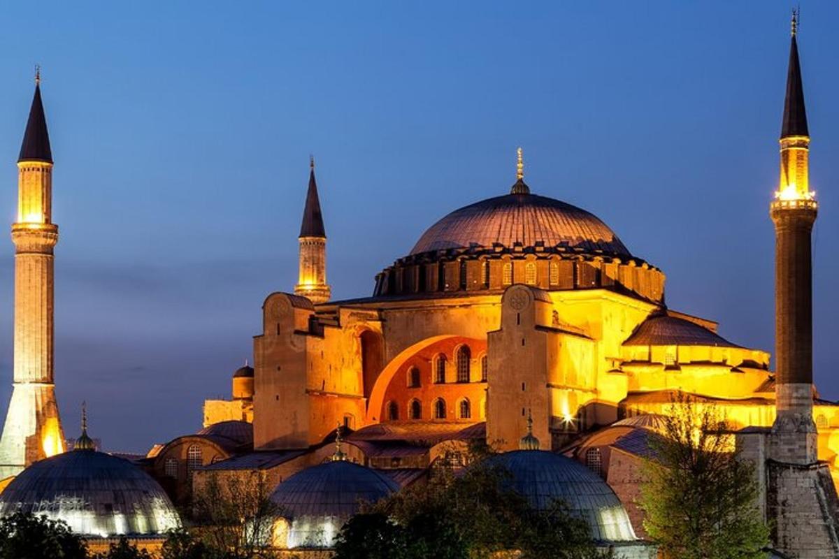 a large building with domes and mosques at night