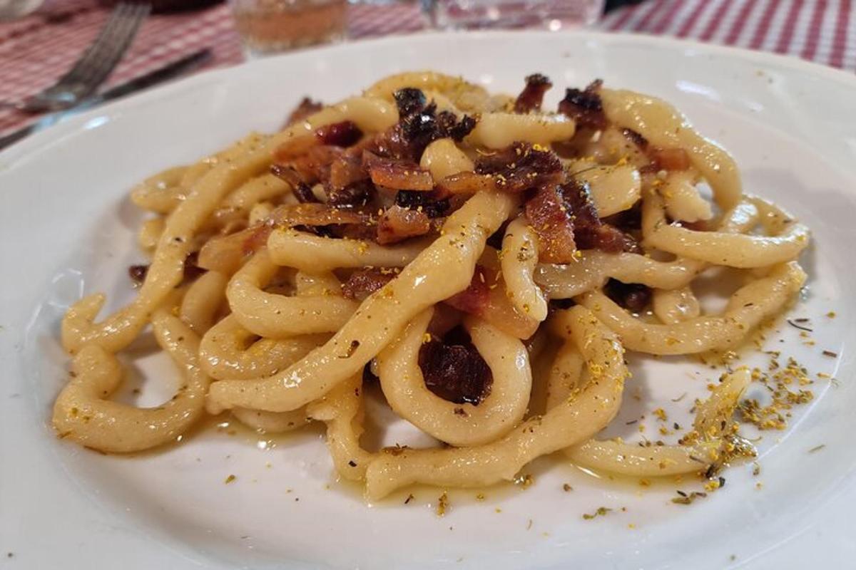 a white plate of food with pasta on a table