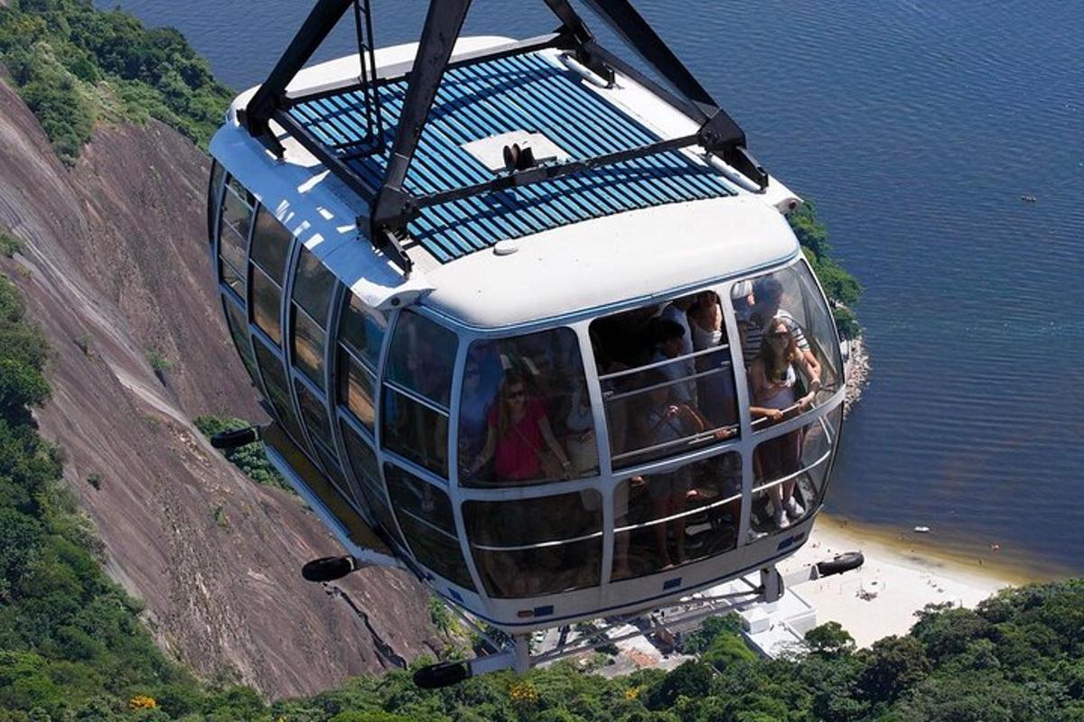 a cable car that is flying over a beach