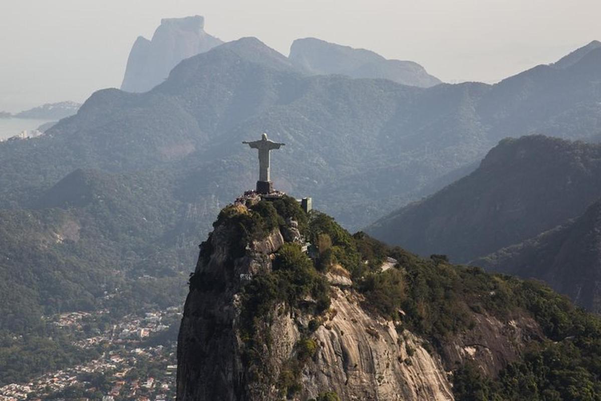 a statue of christ the redeemer on top of a mountain