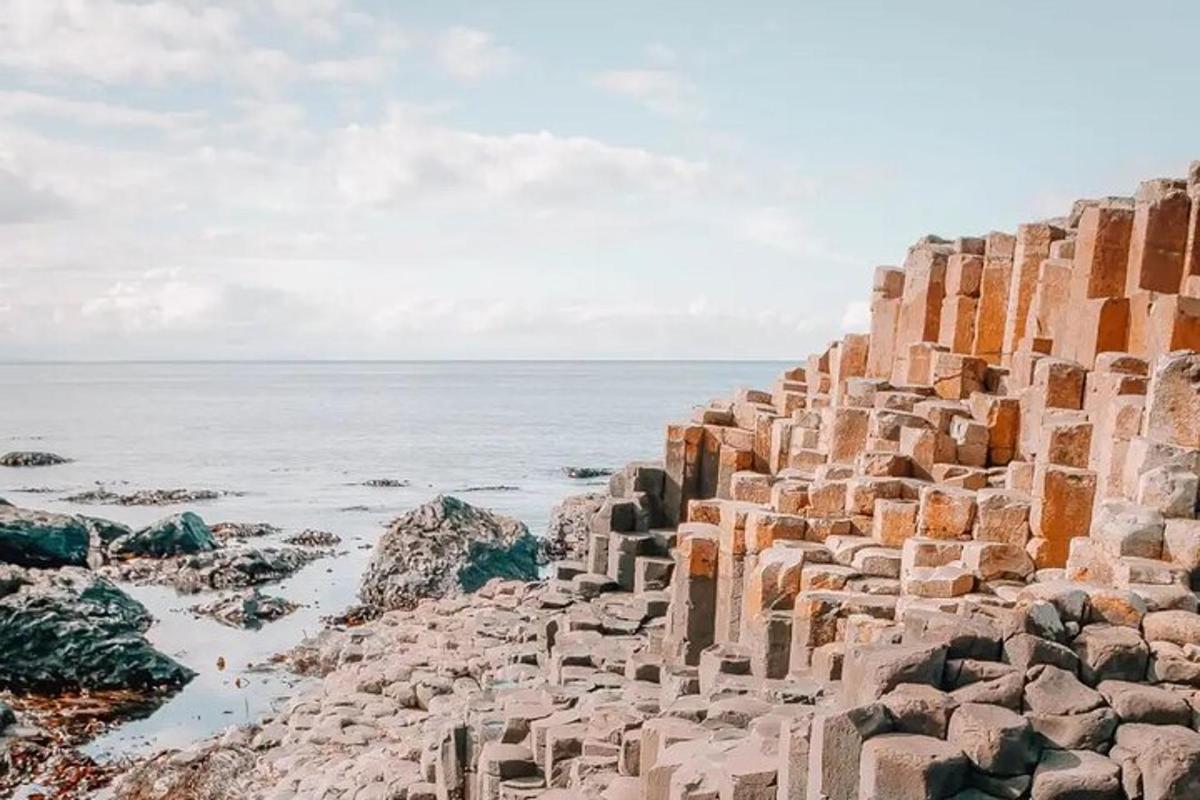 an old stone wall next to the ocean