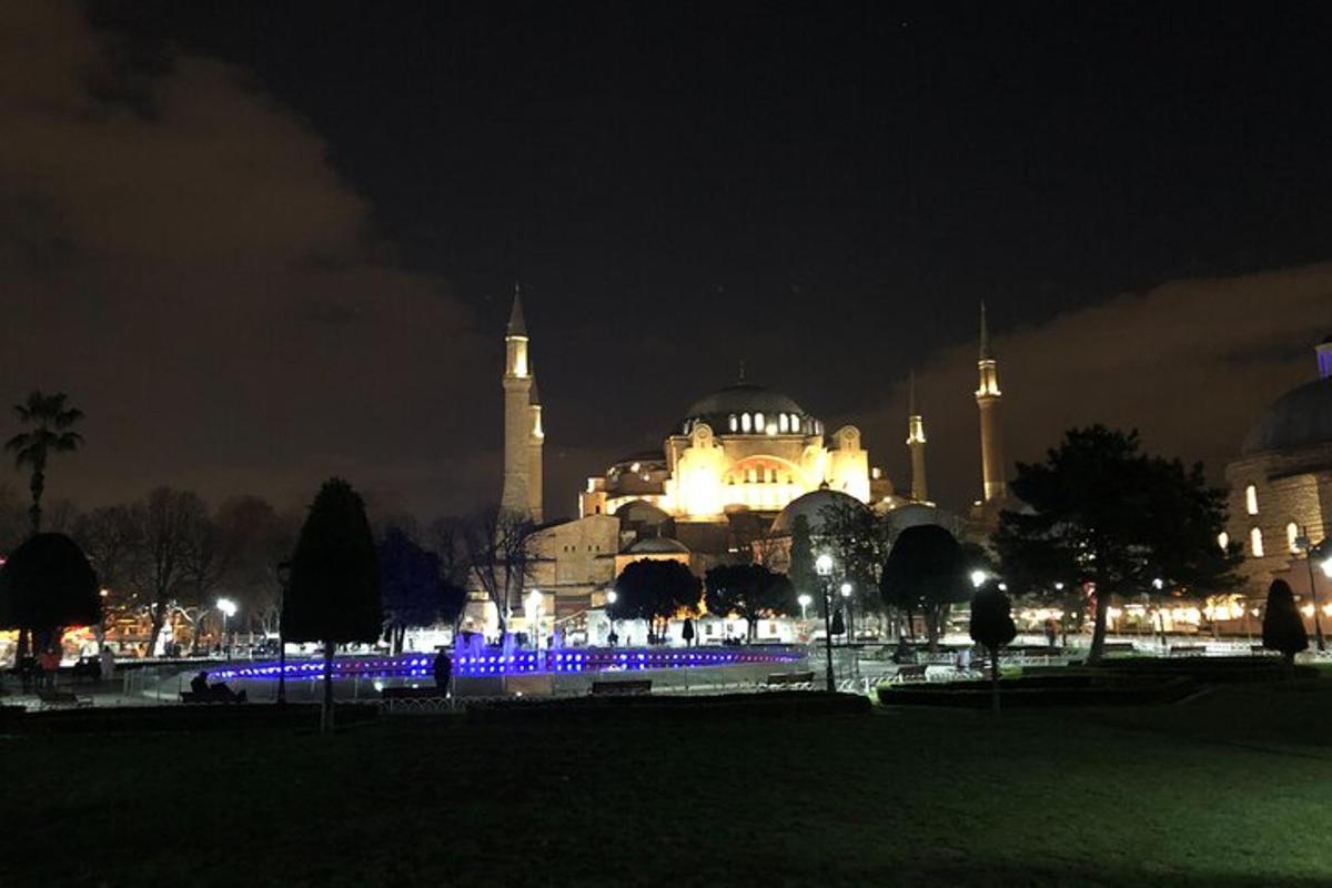 a lit up building with a mosque at night