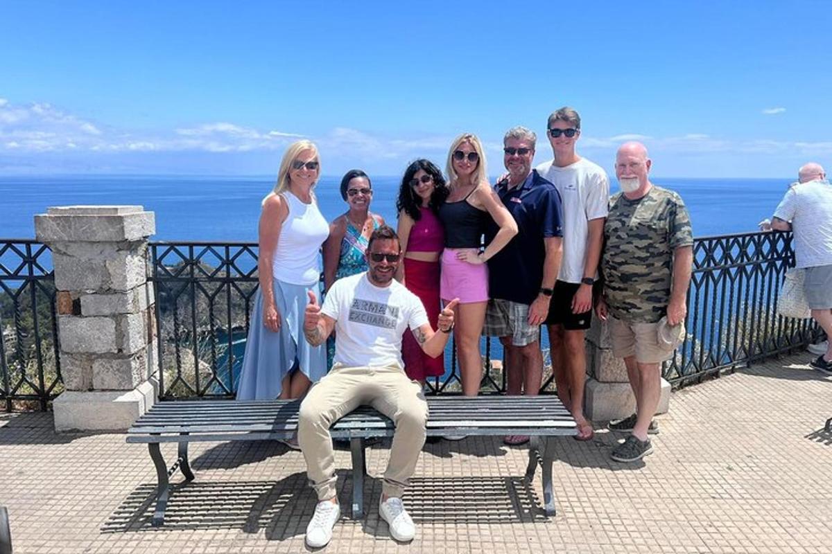 un grup de oameni care pozează pentru o fotografie pe o bancă