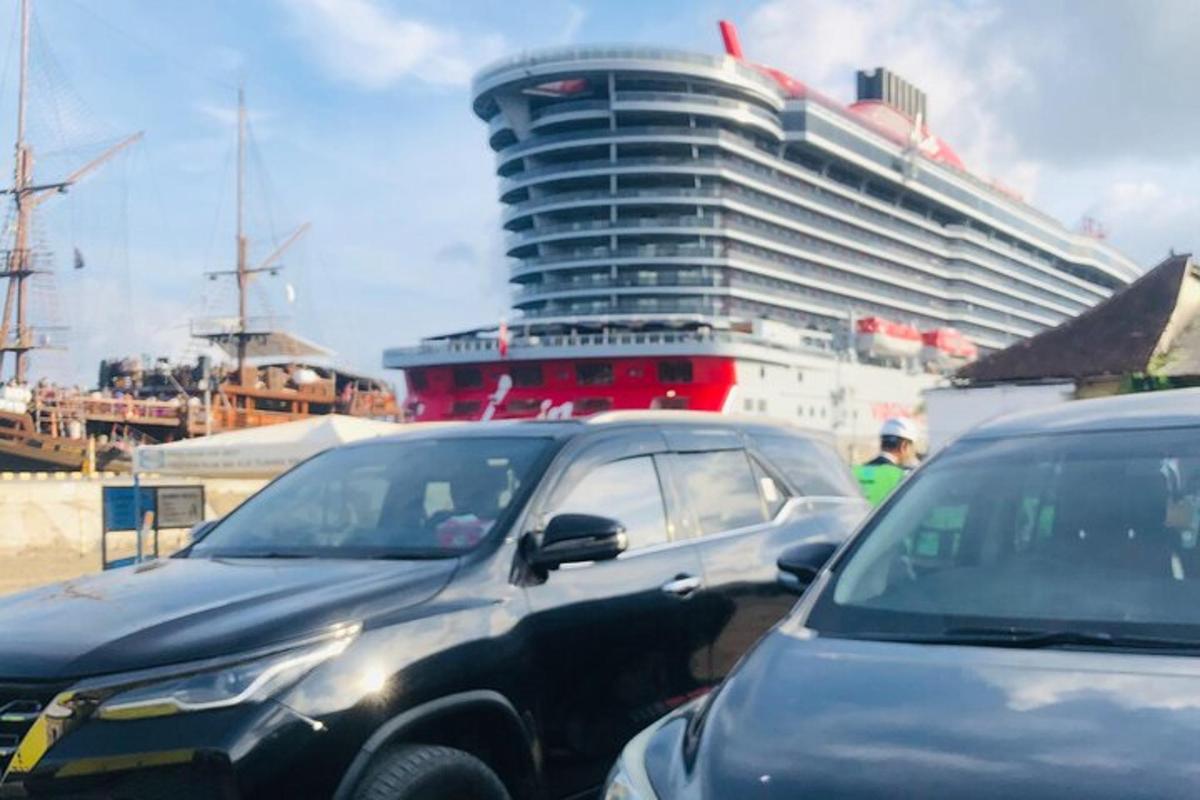 a cruise ship with cars parked in a parking lot