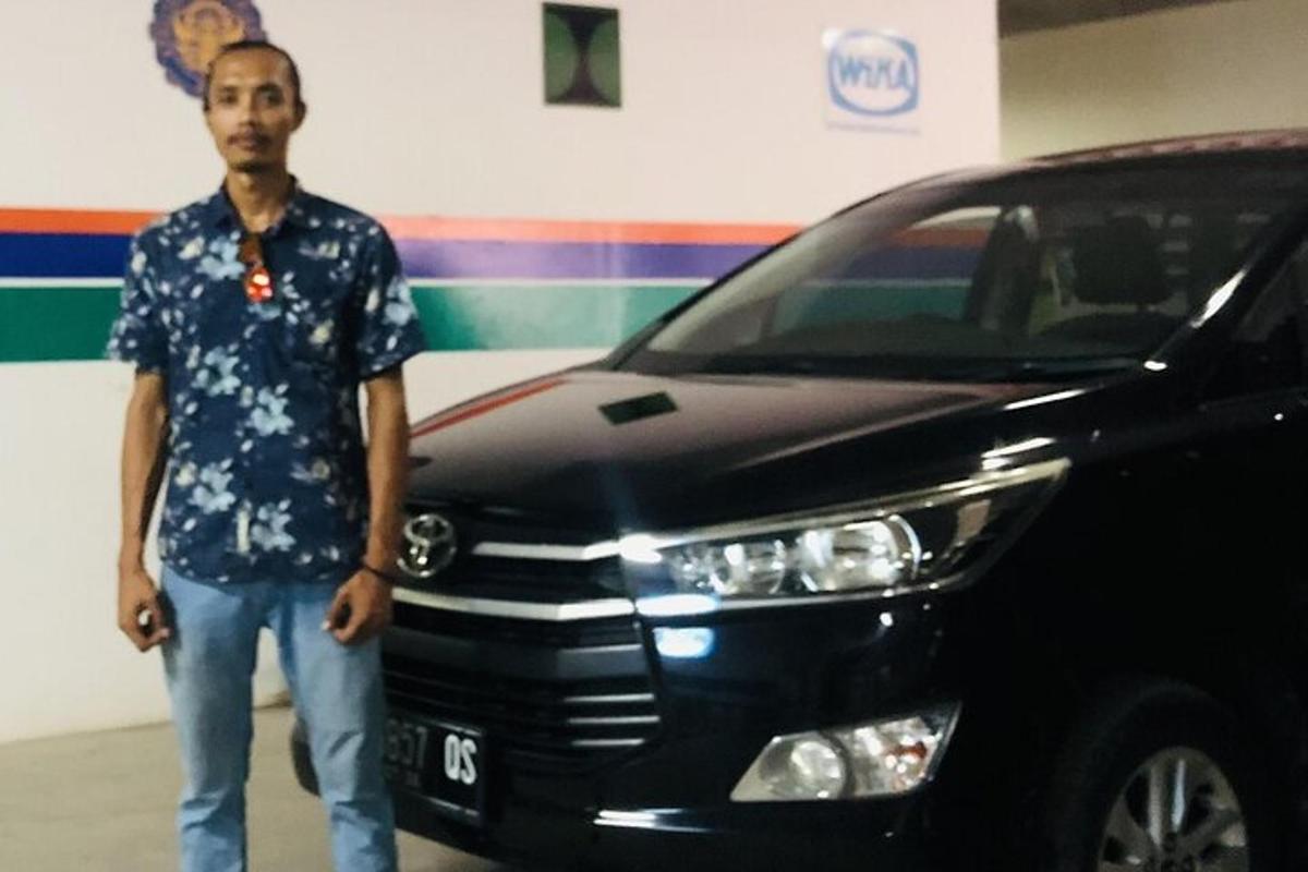 a man is standing in front of a car