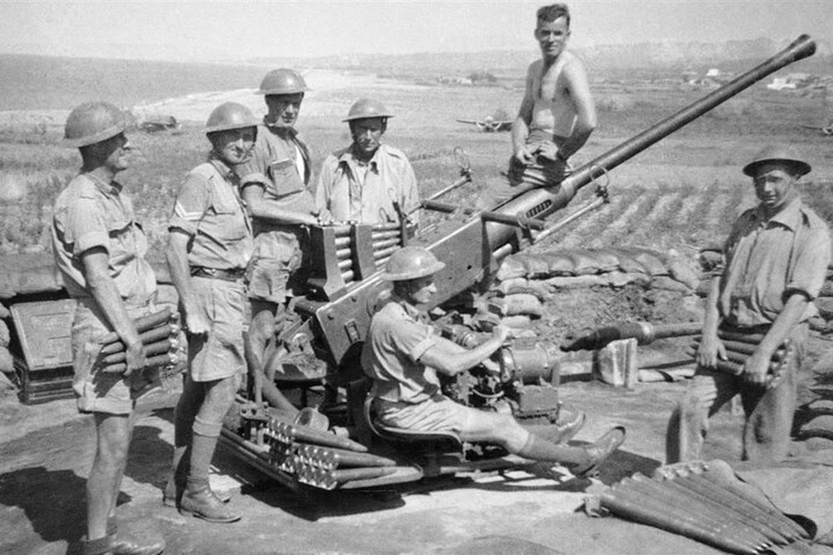 a group of men standing next to a tank