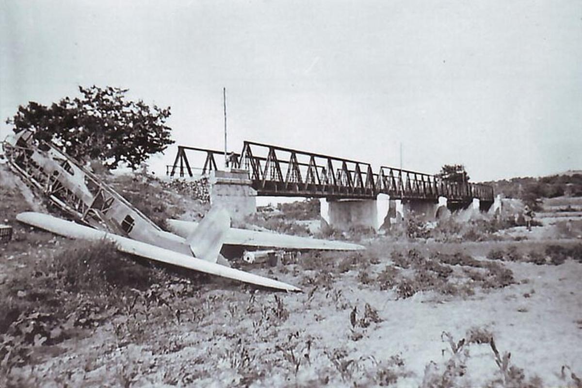 an old photo of a bridge with a train on it