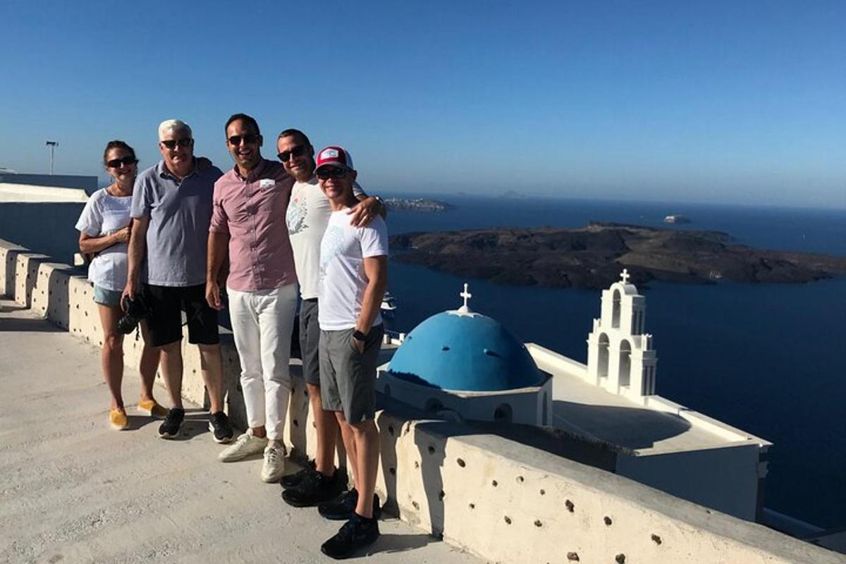 a group of people standing on the edge of a wall